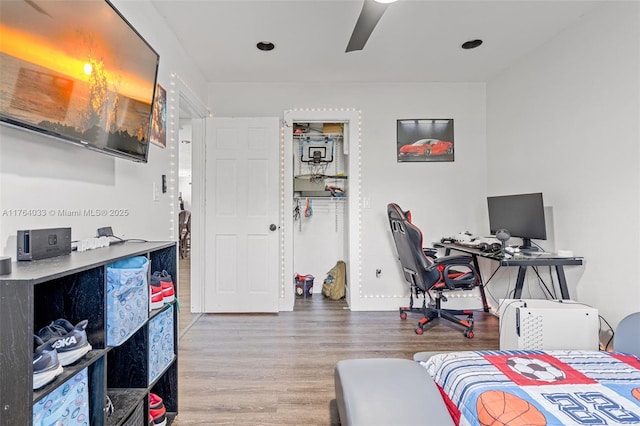 bedroom with wood finished floors and a ceiling fan