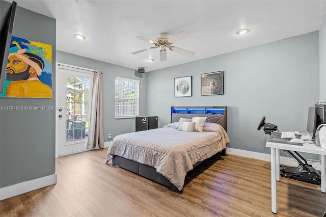 bedroom with ceiling fan, wood finished floors, baseboards, and access to outside