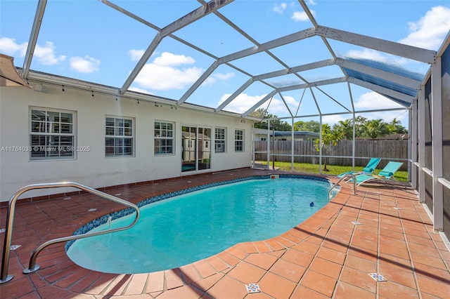 view of swimming pool featuring a fenced in pool, glass enclosure, a patio, and fence