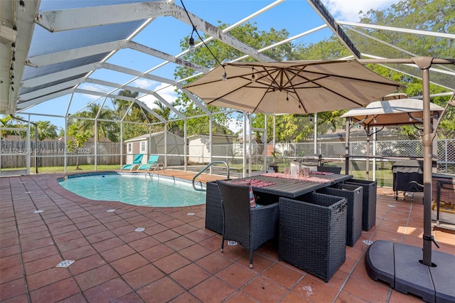 view of pool with a patio, a storage unit, a fenced backyard, and an outdoor structure