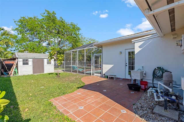 view of yard with glass enclosure, a patio, a storage shed, and an outdoor structure