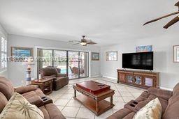 tiled living room with ceiling fan