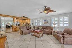 living area featuring light tile patterned floors and a ceiling fan