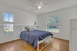 bedroom featuring baseboards and wood finished floors