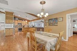 dining room featuring a chandelier and wood finished floors