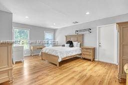 bedroom with recessed lighting and wood finished floors