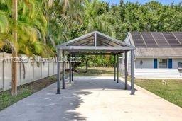 view of property's community with a carport and fence