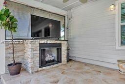 exterior space with ceiling fan and a fireplace