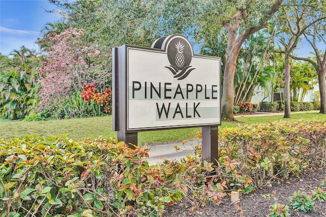 community sign featuring a lawn