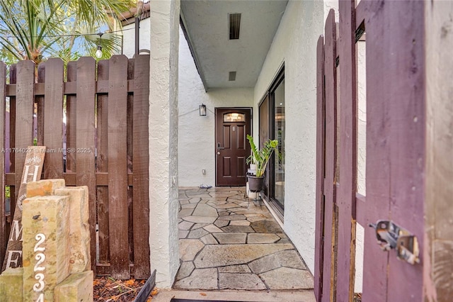 property entrance with stucco siding