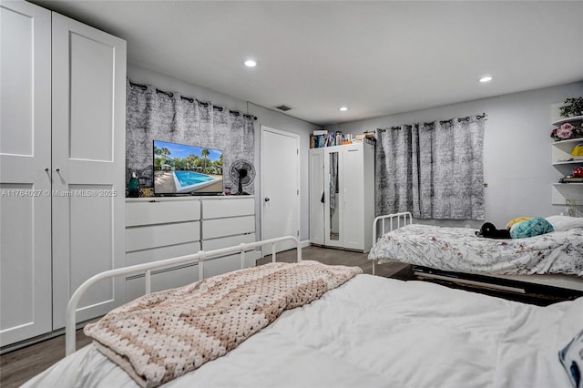 bedroom featuring visible vents, recessed lighting, and wood finished floors