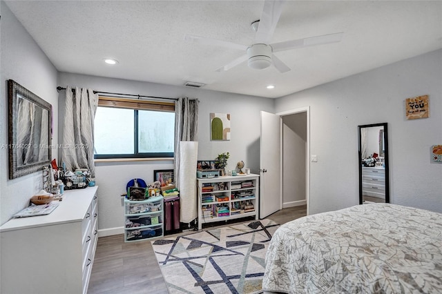 bedroom featuring baseboards, light wood-style flooring, recessed lighting, ceiling fan, and a textured ceiling