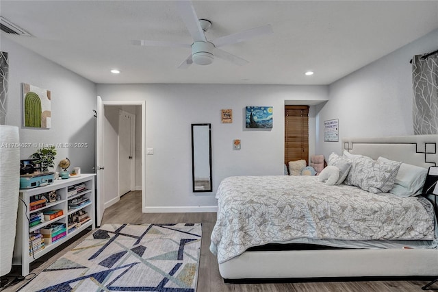 bedroom featuring recessed lighting, wood finished floors, visible vents, and baseboards