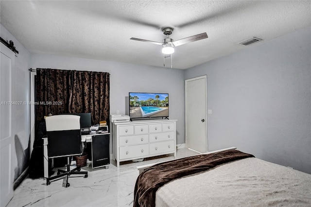 bedroom featuring visible vents, a textured ceiling, marble finish floor, and a ceiling fan