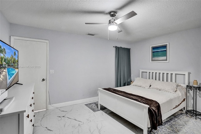 bedroom featuring visible vents, baseboards, a textured ceiling, and marble finish floor