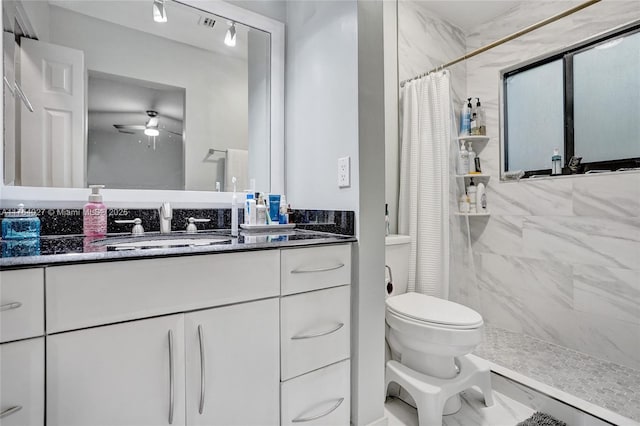 full bath featuring vanity, a shower stall, a ceiling fan, and toilet