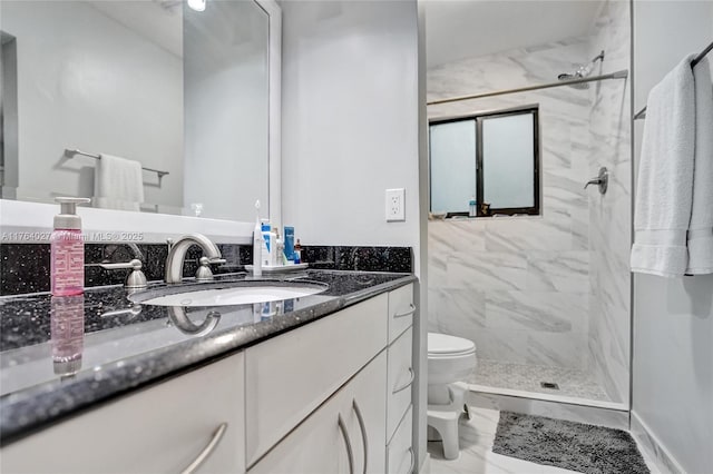 bathroom featuring a marble finish shower, marble finish floor, vanity, and toilet