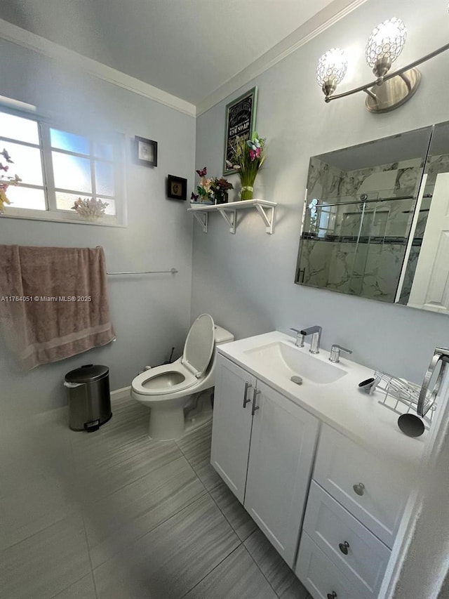 full bath with a marble finish shower, toilet, vanity, and ornamental molding