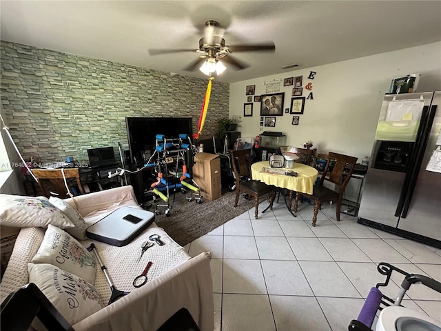 interior space featuring light tile patterned floors, visible vents, and a ceiling fan