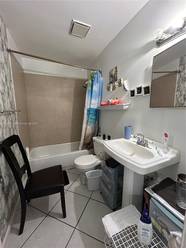 bathroom featuring a sink, toilet, shower / bath combo, and tile patterned flooring