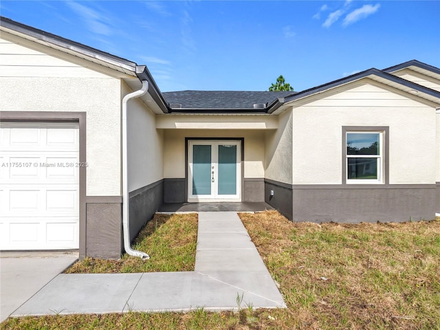 property entrance with french doors, a garage, a shingled roof, and stucco siding