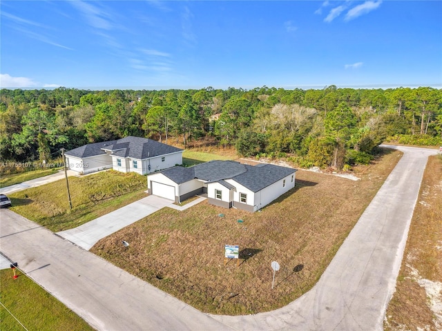 bird's eye view featuring a wooded view