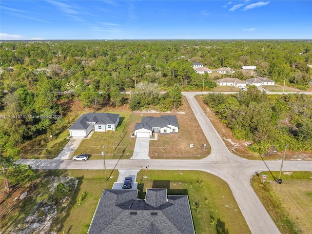 birds eye view of property with a view of trees