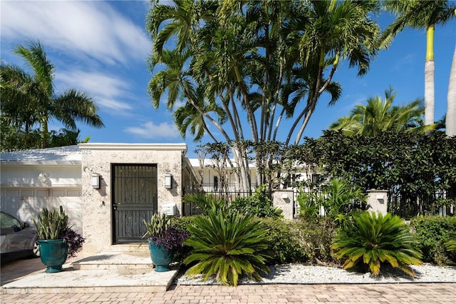 property entrance featuring stucco siding and a garage