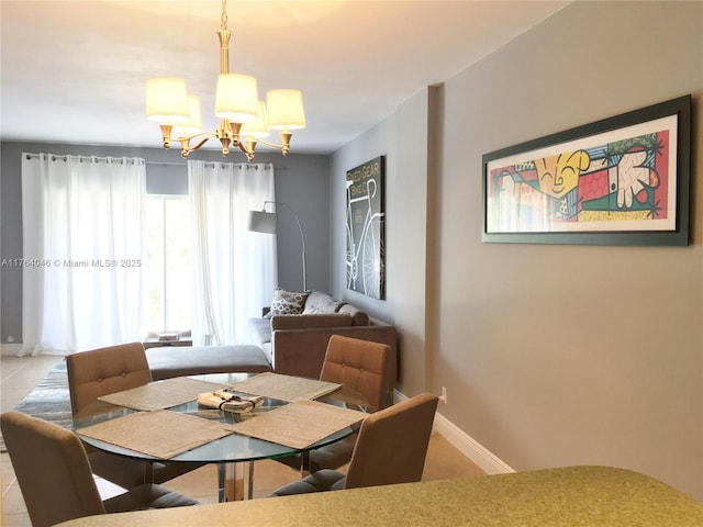 dining space with baseboards, an inviting chandelier, and tile patterned flooring