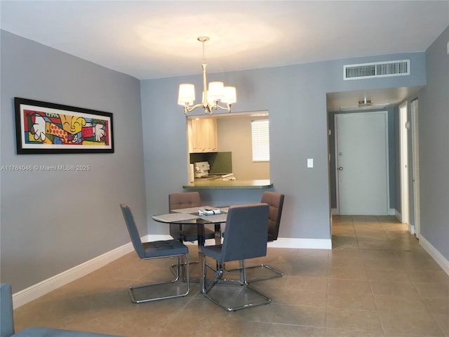 dining space with tile patterned floors, visible vents, baseboards, and a notable chandelier