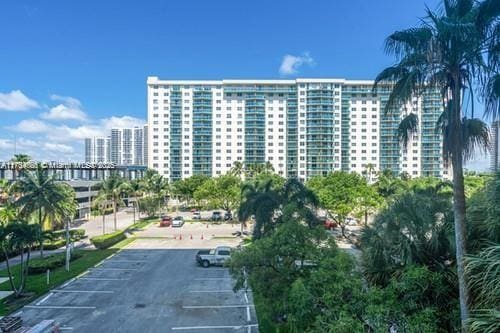 view of building exterior featuring a view of city and uncovered parking