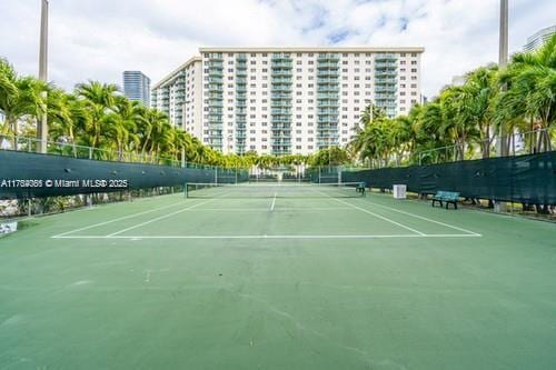 view of tennis court with fence