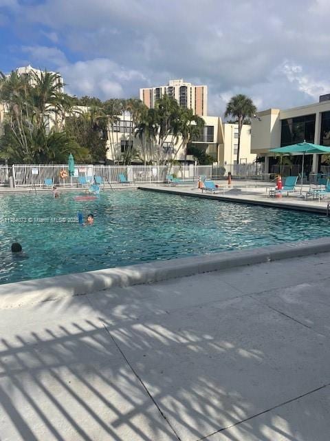 pool featuring a patio area and fence