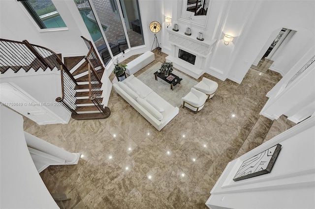 living room featuring stairway and a fireplace