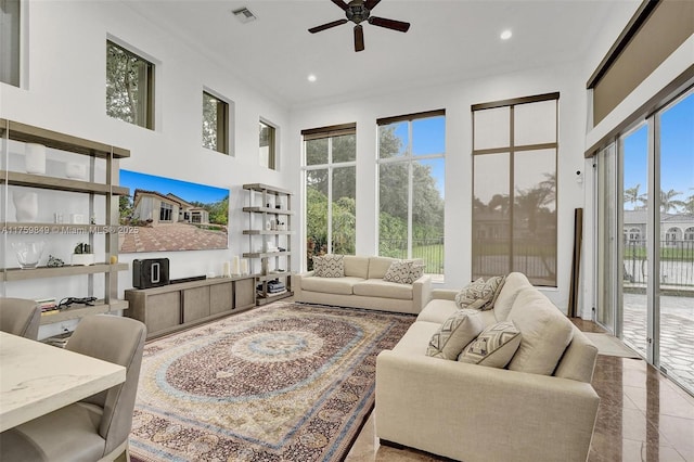 living room featuring recessed lighting, visible vents, a towering ceiling, and a ceiling fan