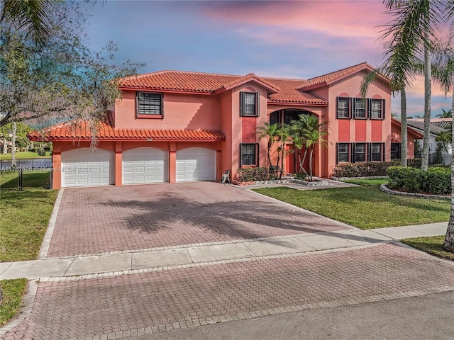 221 NW 201st Ave, Pembroke Pines, FL 33029 - mediterranean / spanish home featuring stucco siding, a tiled roof, decorative driveway, and an attached garage