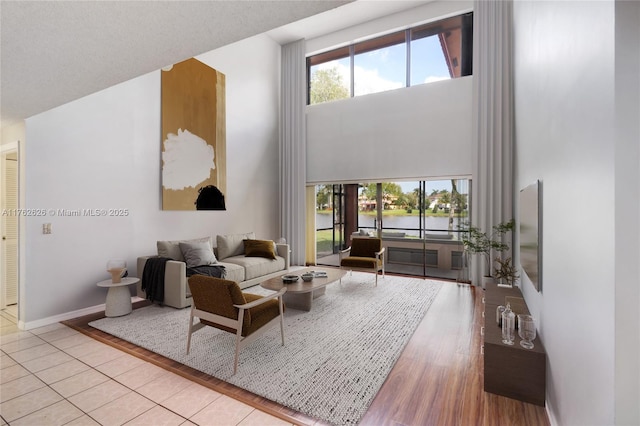 221 NW 201st Ave, Pembroke Pines, FL 33029 - living area with a towering ceiling, wood finished floors, and baseboards