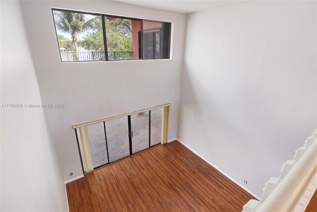 221 NW 201st Ave, Pembroke Pines, FL 33029 - empty room featuring wood finished floors, baseboards, and a towering ceiling