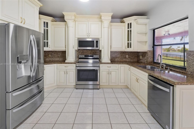 221 NW 201st Ave, Pembroke Pines, FL 33029 - kitchen with appliances with stainless steel finishes, decorative columns, a sink, and tasteful backsplash