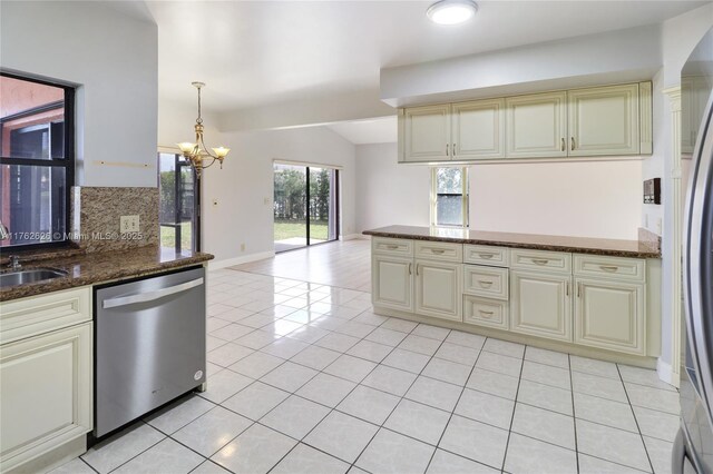 221 NW 201st Ave, Pembroke Pines, FL 33029 - kitchen featuring cream cabinets, appliances with stainless steel finishes, vaulted ceiling, a chandelier, and light tile patterned flooring