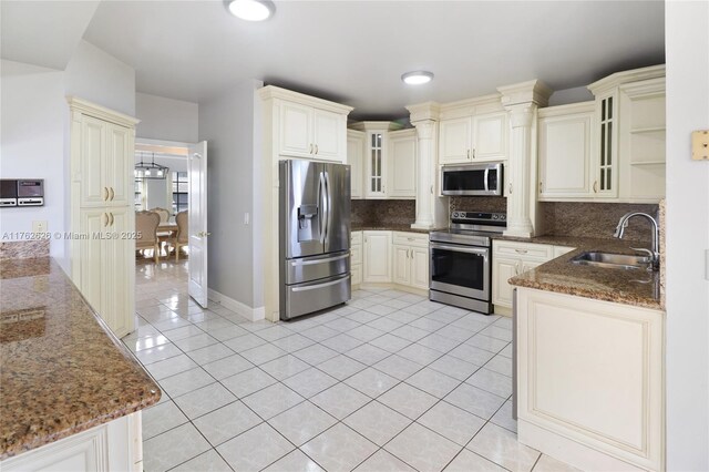 221 NW 201st Ave, Pembroke Pines, FL 33029 - kitchen featuring stainless steel appliances, a sink, light tile patterned floors, backsplash, and dark stone counters