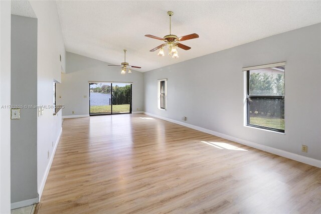 221 NW 201st Ave, Pembroke Pines, FL 33029 - spare room with ceiling fan, vaulted ceiling, light wood finished floors, baseboards, and a textured ceiling
