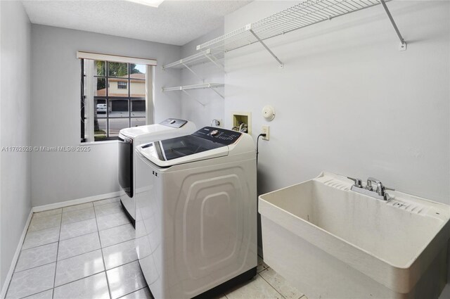 221 NW 201st Ave, Pembroke Pines, FL 33029 - washroom featuring washing machine and clothes dryer, baseboards, and light tile patterned floors