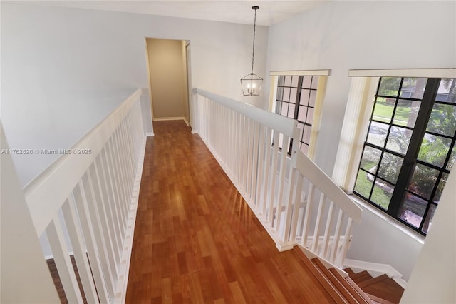 221 NW 201st Ave, Pembroke Pines, FL 33029 - hallway with wood finished floors, a chandelier, and baseboards