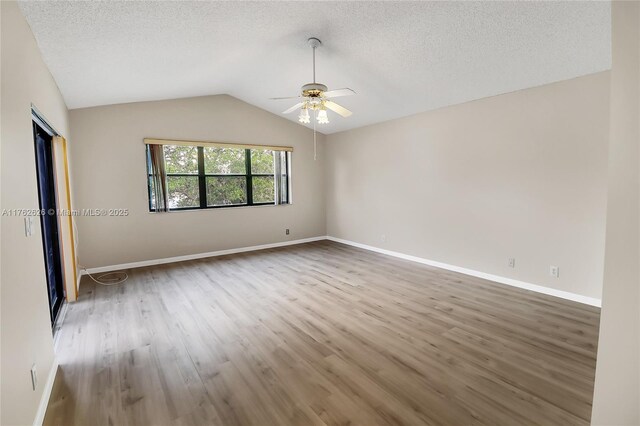 221 NW 201st Ave, Pembroke Pines, FL 33029 - unfurnished room with ceiling fan, wood finished floors, a textured ceiling, vaulted ceiling, and baseboards
