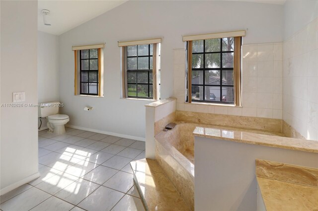 221 NW 201st Ave, Pembroke Pines, FL 33029 - bathroom with tile patterned floors, lofted ceiling, a garden tub, toilet, and baseboards