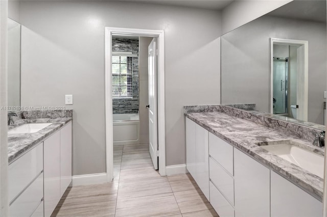 221 NW 201st Ave, Pembroke Pines, FL 33029 - full bathroom with baseboards, vanity, a tub, and tile patterned floors
