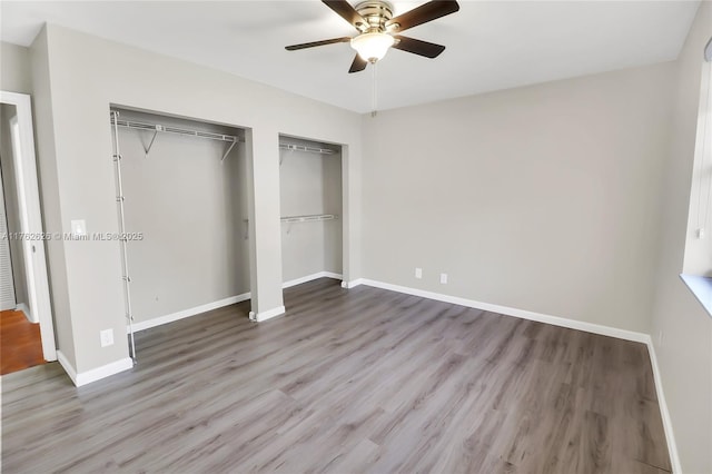 unfurnished bedroom with a ceiling fan, baseboards, and wood finished floors