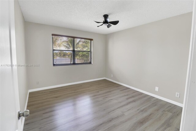 221 NW 201st Ave, Pembroke Pines, FL 33029 - spare room with a textured ceiling, a ceiling fan, wood finished floors, and baseboards