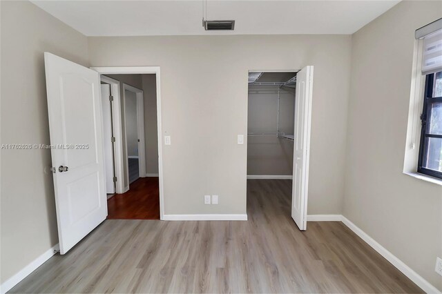 221 NW 201st Ave, Pembroke Pines, FL 33029 - unfurnished bedroom featuring light wood-style floors, baseboards, and a closet